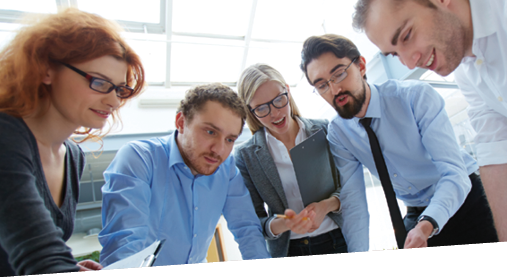 Team of engineers discussing blueprint at meeting